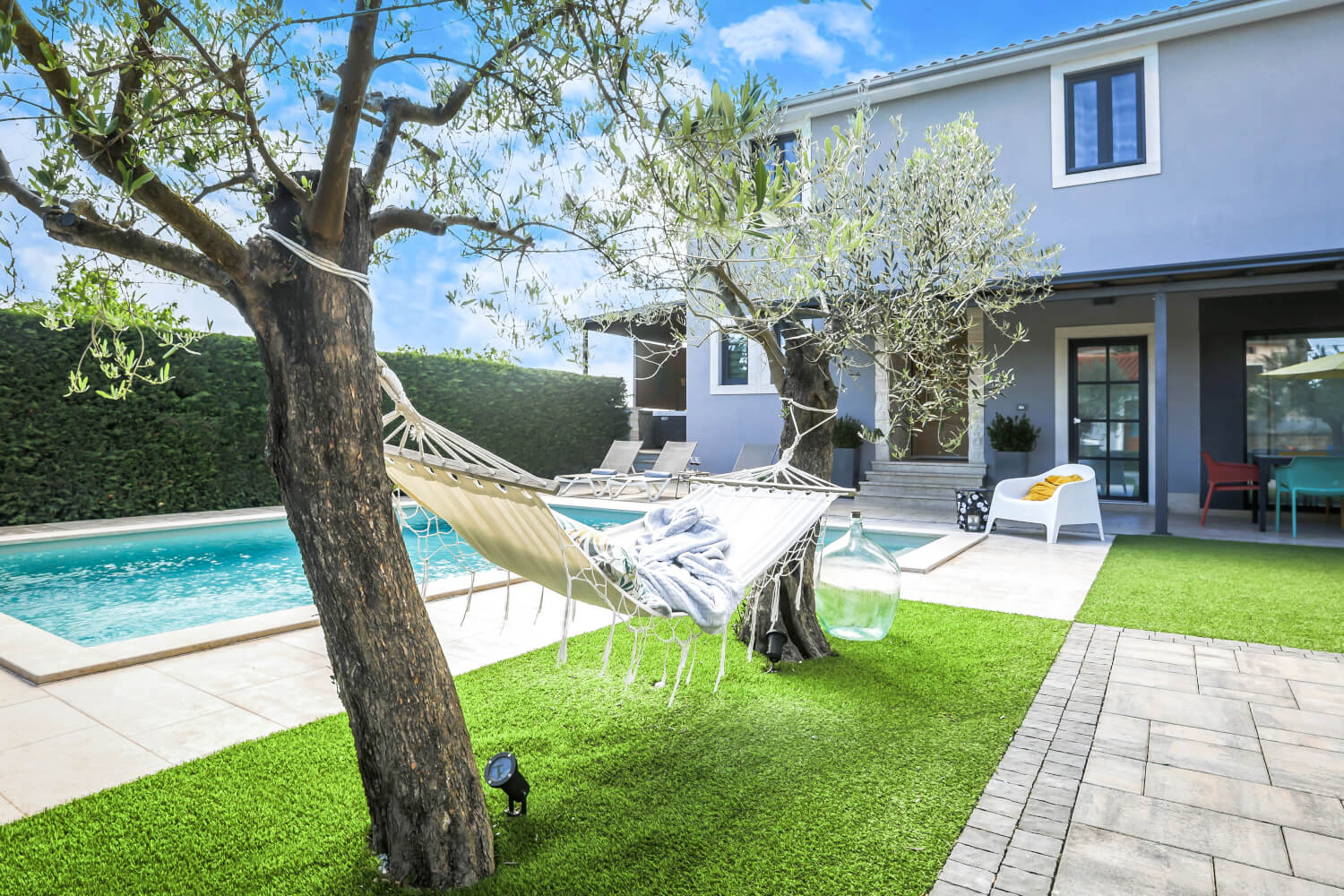 pool with olive trees and hammock